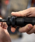 Close-up of hands holding Long Barrel Air Hammer For Heavy Duty Demolition And Workshop Use, 2300 Blows Per Minute, 3.75 Inch Stroke