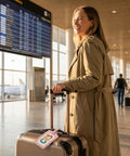 Four Pack No Fuss Needlepoint Luggage Tags Featuring Slick Faux Leather Shell And Crystal Clear Id Window Built To Snugly Cradle Any Finished 2X3 Inch Stitch Canvas For Smooth Road Trip Adventures on a suitcase at the airport.
