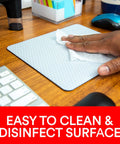 Hand cleaning Precise Mouse Pad With Repositionable Adhesive Back For Optical Mice At High Speeds on wooden desk