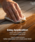 Application of Natural Linseed Oil Wood Protector And Clear Varnish 500 Ml onto wooden surface with cloth.