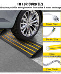 Car wheel on rubber curb ramp set for driveway two pack threshold bridge with reflective safety strips and grooves.