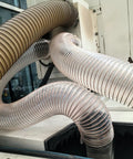 Transparent dust collection hoses for woodworking, connecting shop vacuum to tools, heavy-duty, flexible, puncture-proof design.