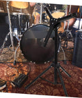 Hella Sturdy 12 Fold Snare Drum Stand Rack With Heavy Duty Accessory Holder For Practice Pads And Gear Compact Road Ready Top Shelf Black Finish in a studio.