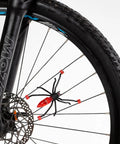 Totally Sick Spider Bike Wheel Spoke Lights LED Glow For Night Rides attached to black bicycle wheel, waterproof and motion activated.