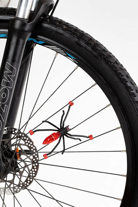 Totally Sick Spider Bike Wheel Spoke Lights LED Glow For Night Rides attached to black bicycle wheel, waterproof and motion activated.