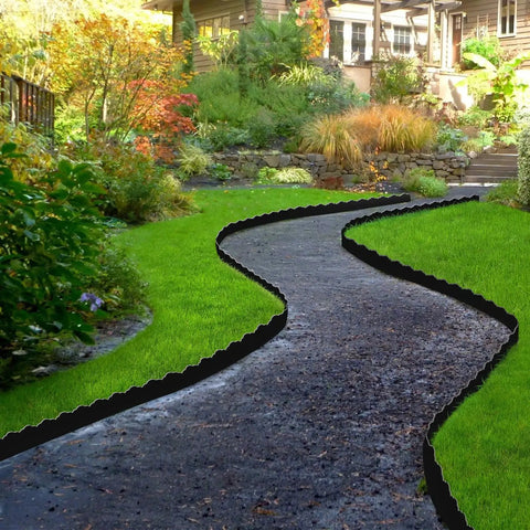 Durable 33 Ft No Dig Landscape Edging Border With 50 Spikes 4 Inch Tall Plastic Lawn Edging For Yard Pathways And Flower Beds Black Cloud Shaped Design Easy Install next to a garden path.