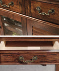 Six Piece Set Of Vintage Drop Bail Drawer Pulls In Antique Bronze Finish installed on wooden cabinet drawers