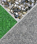 Close-up of a sectioned garden layout with green grass, pebbles, and gravel, showcasing a variety of landscaping materials.