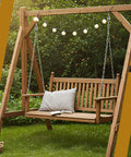 Wooden porch swing with chains hanging securely, showcasing potential use for Six Pack Heavy Duty Swing Springs, 3000 Lbs Capacity