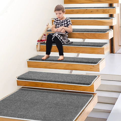 Child on stairs with Grey Stair Tread Carpet Runner Set With Adhesive Backing And Nonskid Grip For Easy Install 14 Plus 1 Pieces