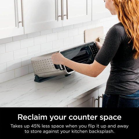 Woman storing Digital Air Fry Pro Countertop Oven With Extended Height And XL Capacity For Big Meals, Flip Up Storage Design on counter.