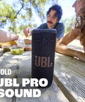 Grip Compact Bluetooth Speaker With Bold Pro Sound and Ambient Light for On The Go Vibes, next to people outdoors