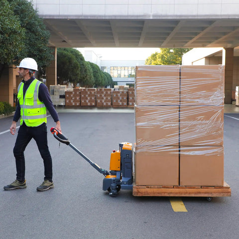 Heavy Duty 3300 Lb Electric Pallet Jack With Smart Control Handle And Fast Lifting moving a pallet of boxed cargo outdoors.