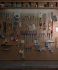 Organized pegboard with tools and Wireless LED Light Switch Tap Light Battery Powered 100 Lumens Peel And Stick Portable Lighting