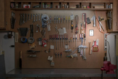 Organized pegboard with tools and Wireless LED Light Switch Tap Light Battery Powered 100 Lumens Peel And Stick Portable Lighting
