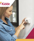 Woman testing Carbon Monoxide Detector Portable CO Alarm With AA Battery Power, LED Indicators, Test Reset Button, Low Battery Indicator
