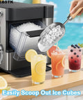 Hand holding stainless steel scoop serving ice cubes from ice maker near fruit drinks