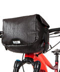 Alpha Handlebar Bag 6 Liter for City Commutes and Bike Tours, Weatherproof Messenger With Roll Top And Tech Pocket, attached to bike.