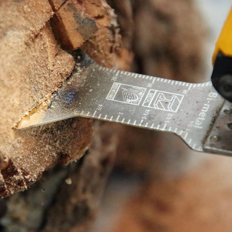 Close-up of Five Piece Universal Oscillating Multitool Blade Set with Titanium Coated M42 HSS Bi Metal Blade cutting wood