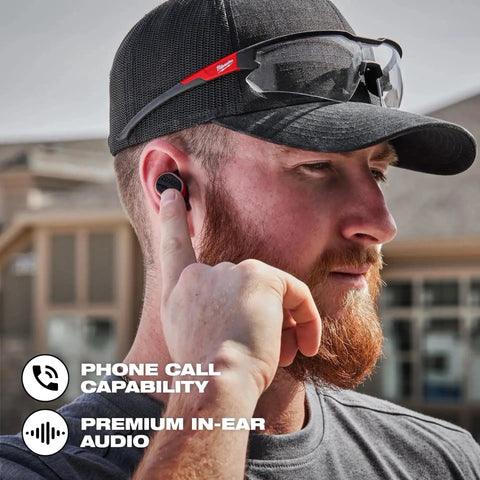 Man using Rugged USB Bluetooth Jobsite Ear Buds With RedLithium Power For Pro Contractors, outdoor worksite setting