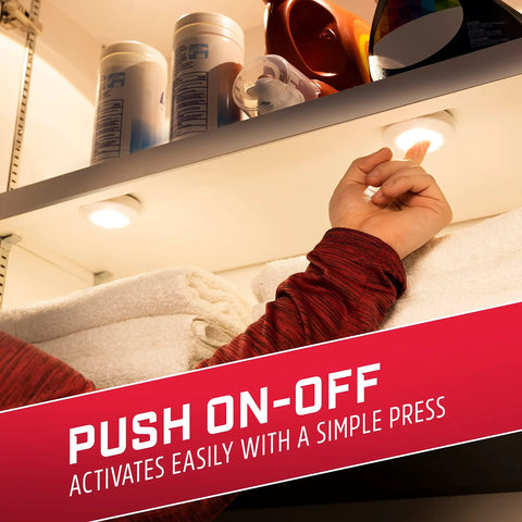 Person pressing a battery-operated LED puck light under a cabinet, showcasing easy installation and operation for closet lighting.