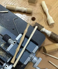 EssSthmy All-Metal Mini Wood Lathe 60W 12,000 RPM with turned wooden spindles on a work surface.