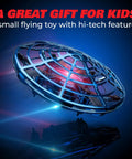 Blue Hand Operated Scoot Drone For Kids And Adults With Hands Free Motion Sensor LED Indoor UFO Toy hovering in dark setting.