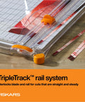 Precision Paper Trimmer With SureCut Wire Cut Line And TripleTrack System detail with orange blade on wooden table