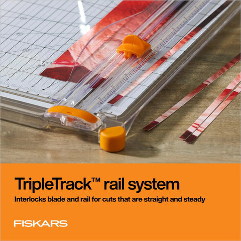 Precision Paper Trimmer With SureCut Wire Cut Line And TripleTrack System detail with orange blade on wooden table