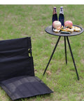 Ultra Lightweight Outdoor Camping Backrest Foldable Chair For Park And Beach Hangout Portable Single Lazy Chair With Aluminum Frame Easy One Step Setup Compact Carry Bag Carbon Black on grass next to picnic table.
