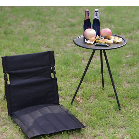 Ultra Lightweight Outdoor Camping Backrest Foldable Chair For Park And Beach Hangout Portable Single Lazy Chair With Aluminum Frame Easy One Step Setup Compact Carry Bag Carbon Black on grass next to picnic table.