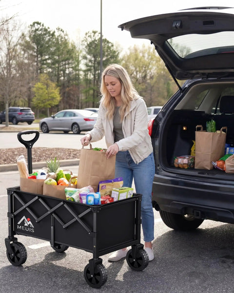 Woman loading groceries into Collapsible Wagon Cart With Wheels Heavy Duty Folding Wagon For Groceries Shopping Outdoor Portable 250 Lb Capacity Trolley Black One Hand Quick Fold For Easy Haul And Storage.