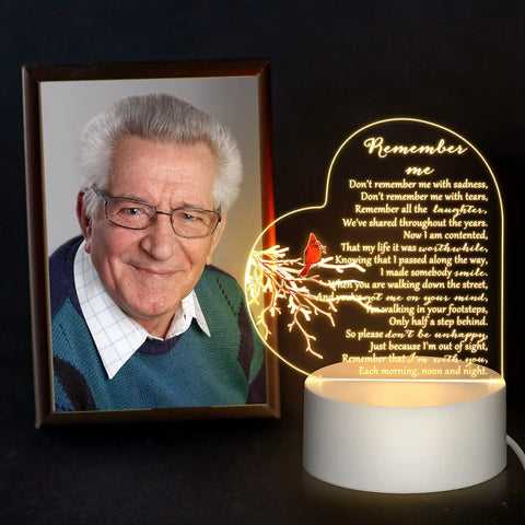 Heart Shaped Memorial Night Light With Clear Crystal Acrylic Base LED Remembrance Sign For Loss Of A Loved One beside a photo.