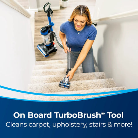 Woman using Straight Up Powerful Upright Vacuum Cleaner With Extending Wand and Massive Dust Bin for cleaning stairs.
