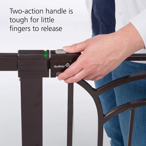 Close-up of a hand operating the secure lock indicator on a Tall And Wide Baby Gate For Doorways With Easy Install No Drilling and Pressure Mount Decor Friendly Design.