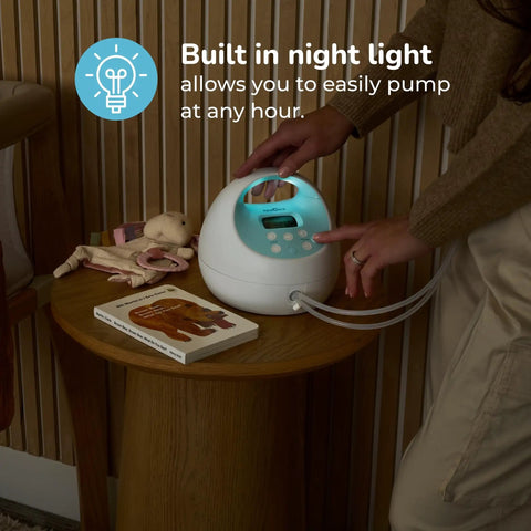 Hassle Free Portable Electric Breast Pump With Rechargeable Battery And Soft Suction Levels Includes Total Must Have Travel Tote Nursing Bottles And Insulated Cooler Bag For Busy Mom Life on a wooden table with night light feature.