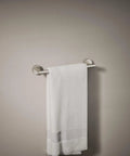 Elate 12 Inch Towel Bar In Vibrant Brushed Nickel Finish For Modern Bathrooms, mounted with towel against gray wall.