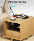Dual Sided Desk Grommet Power Strip With Four AC Outlets And Three USB Ports Including Two Type C Connectors on wooden nightstand.