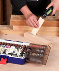 WORKPRO 476-Piece Rotary Tool Accessories Kit in blue case with assorted bits; person uses rotary tool on wood.