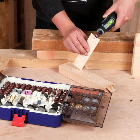 WORKPRO 476-Piece Rotary Tool Accessories Kit in blue case with assorted bits; person uses rotary tool on wood.