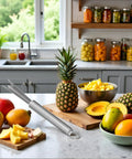 Stainless Steel Pineapple Eye Remover Tool With V Shaped Cutter And Ergonomic Handle For Home Kitchen Prep on counter with fruit