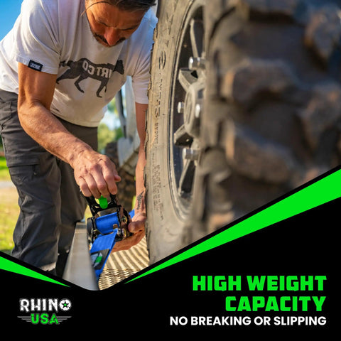 Man securing tire with Heavy Duty Retractable Ratchet Straps 2 Inch By 10 Feet, 3033 Pound Break Strength, 2-Pack Self Retracting Tie Down Straps For Truck, Trailer, Motorcycle And Gear Blue