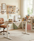 Sleek Tile Adjustable Height Sewing Table, 47 Inch Maple Workbench With Smart Memory Presets in a crafting studio setup.