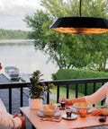Couple dining outdoors with Hangin Infrared Outdoor Heater With LED Light And Remote 400W And 1500W Heat Settings