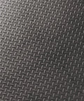 Close-up of the diamond plate surface of Interlocking Rubber Floor Tiles 18x18 Inch Diamond Plate Squares That Are Tough-As-Nails For Home Gym Garage.