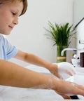 Child washing hands in a sink, demonstrating use of Electric Mini-Tank Water Heater Tronic 3000 T 2.5 Gallon ES2.5 Hot Water On Tap