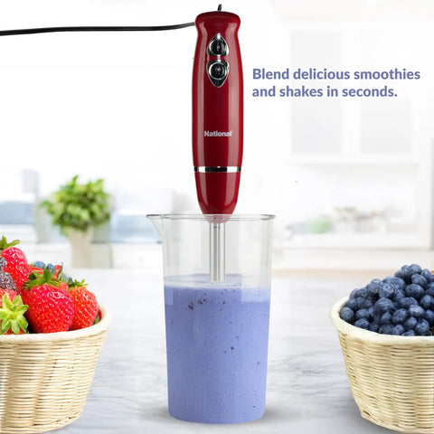 Heavy Duty 4 In 1 Immersion Hand Blender With Rock Solid 500W Motor And Two Speed Settings Featuring Splash Control Tech And Versatile Attachments For Your Daily Kitchen Hustle blending smoothie in measuring cup.