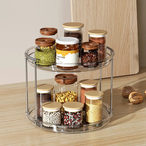 2 Tier Lazy Susan Turntable Organizer For Narrow Cabinets, showcasing clear plastic, two-tier design with spice jars on kitchen countertop.