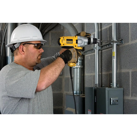 Man using Corded Hammer Drill Kit With Half Inch Capacity And Ten Amp Power For Masonry Wood And Steel Drilling Dual Mode Hammer And Drill Built For Pros And Serious DIYers Who Need Beefy Power on concrete wall