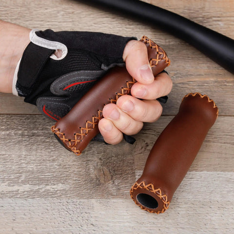 Cyclist holding soft cushioned 127mm vinyl MTB grips for mountain bikes and beach cruisers beefy comfort grips.